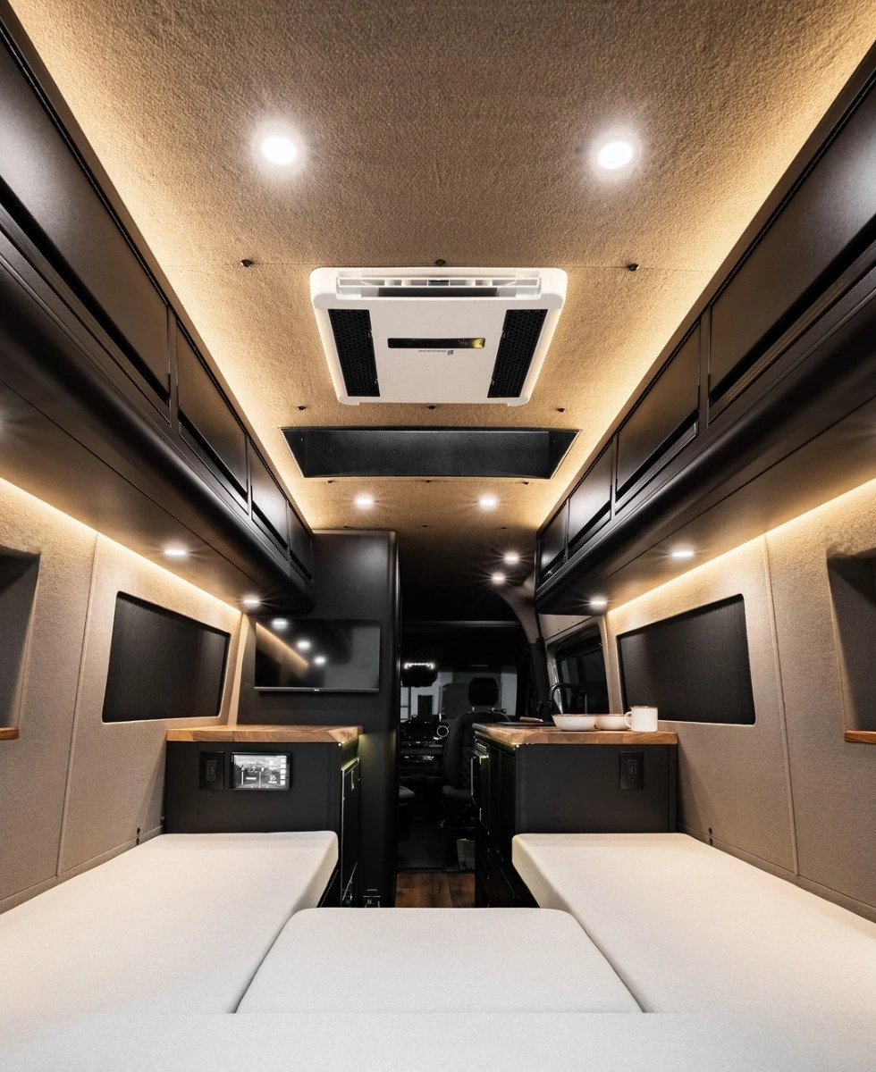 OmegaVan cream bed cushions, black cabinets and wood counters
